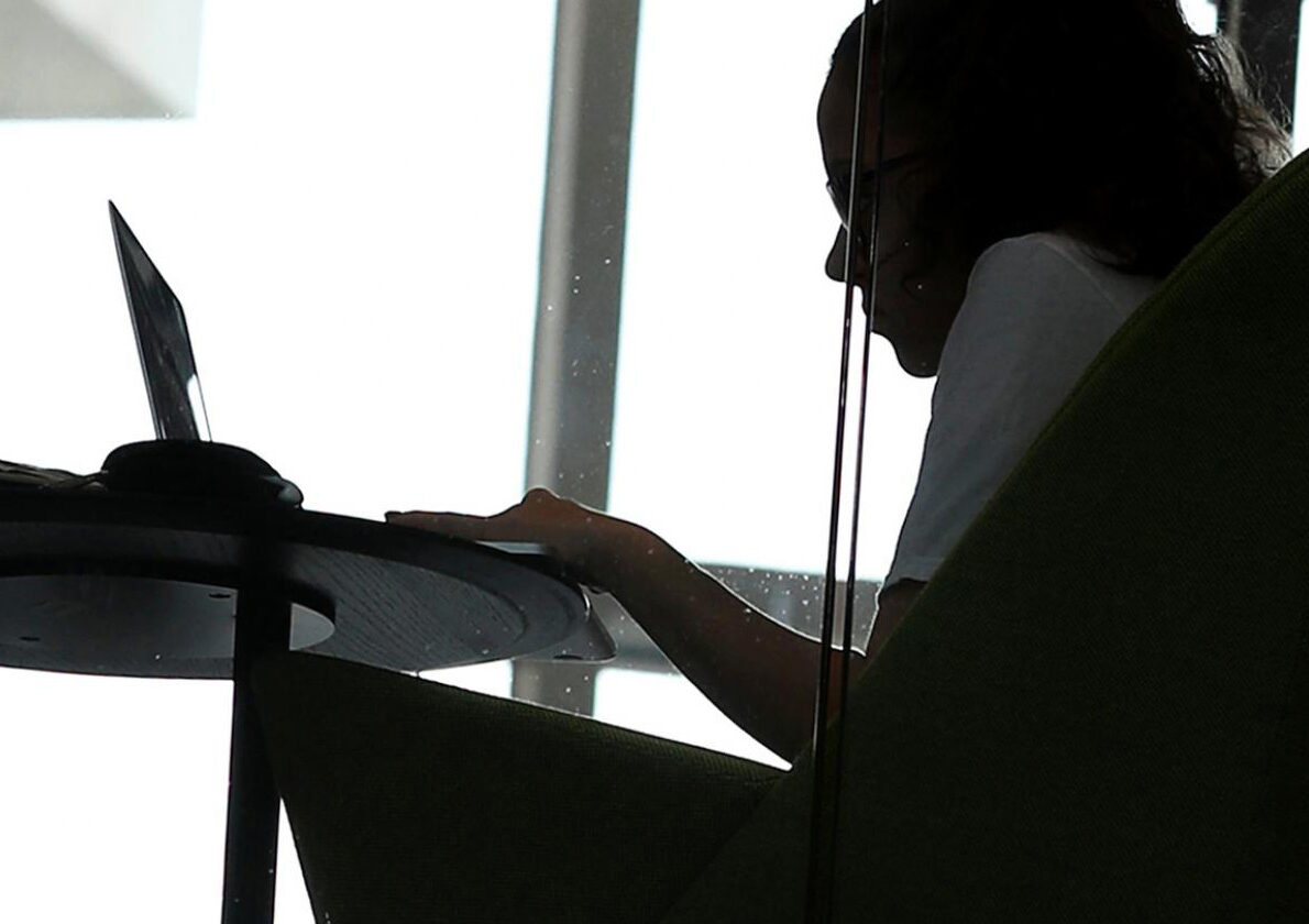 Student working on a laptop in Wall